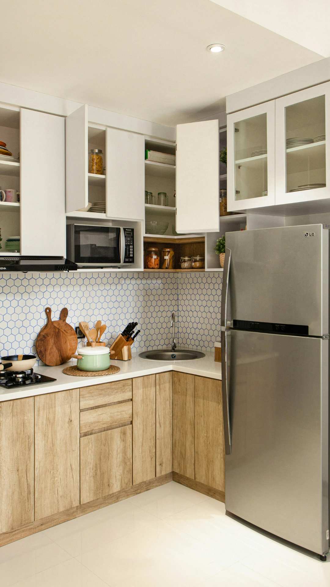 Modern-small-kitchen-makeover-ideas-on-a-budget-featuring-light-wood-cabinets-white-counters-and-simple-decor-that-makes-the-space-feel-warm-and-inviting