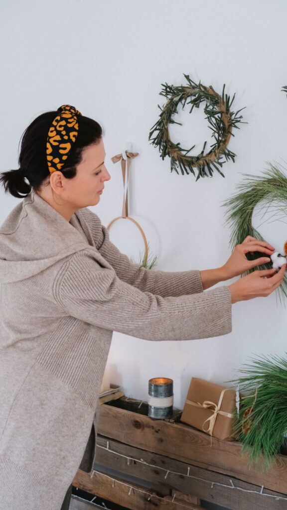 Woman-styling-living-room-with-plant.