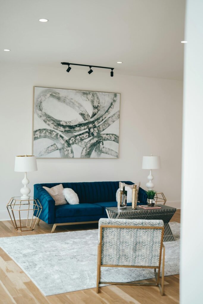 Bright-living-room-with- a- deep-navy-blue- couch- wall-art-and-white-walls-showing-the-beauty-of-small-space-decorating-ideas.