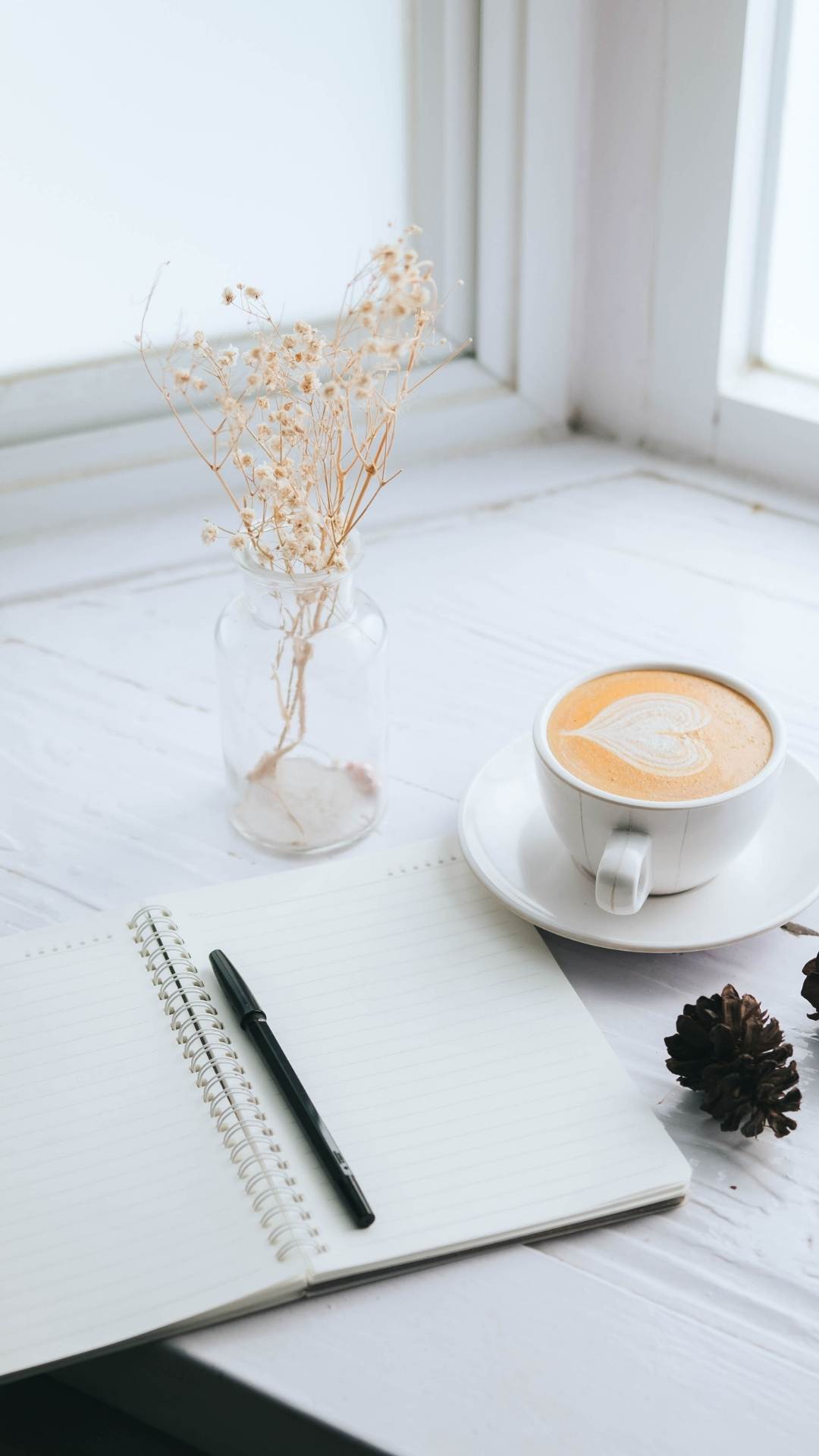 An-image-of-a-white-journal-a-coffee-and-a-verse-of-flower-on-table