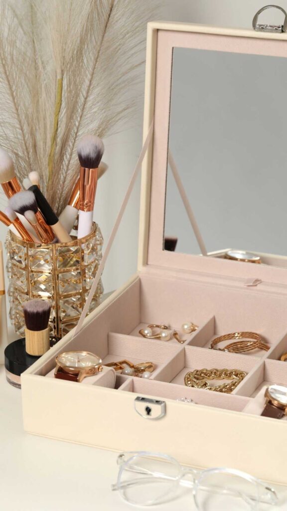 A-jewelry-box-that-contains-accessories-you-can-pair-your-new-year's-outfit-ideas-with-and-make-up-brush-beside-it