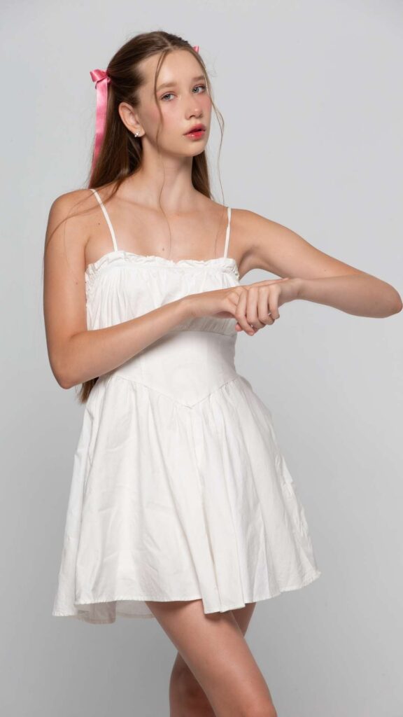 A-picture-of-a-girl-wearing-a-mini-white-gown-for-a-new-year-celebration-with-families-as-a-dress-code-ideas-for-a-new-year's-party-celebration