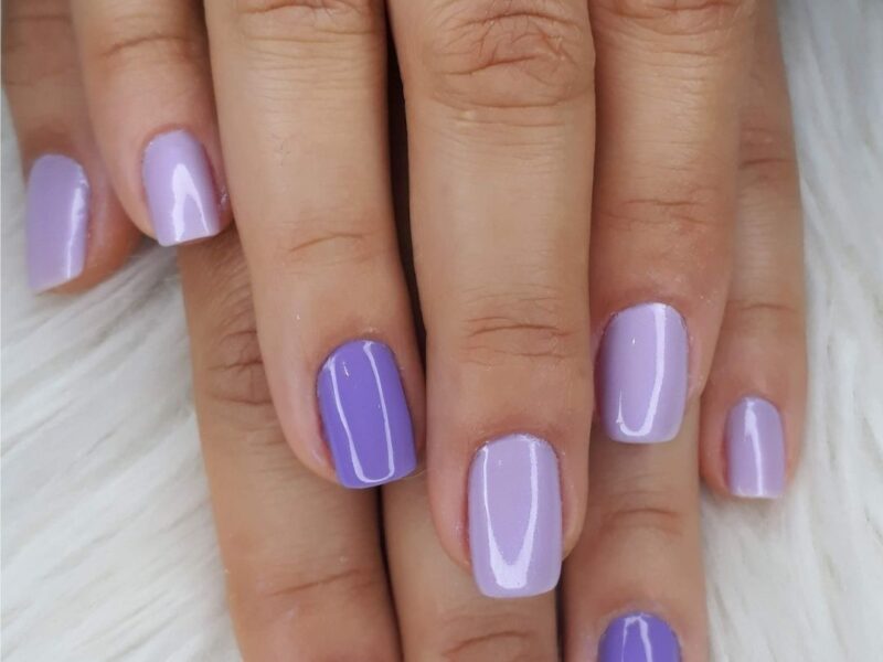 A-woman-showing-her-painted-finger-nail-with-mixture-of-light-purple-and-dark-purple-nails-as-one-of-the-30-new-year-nail-designs