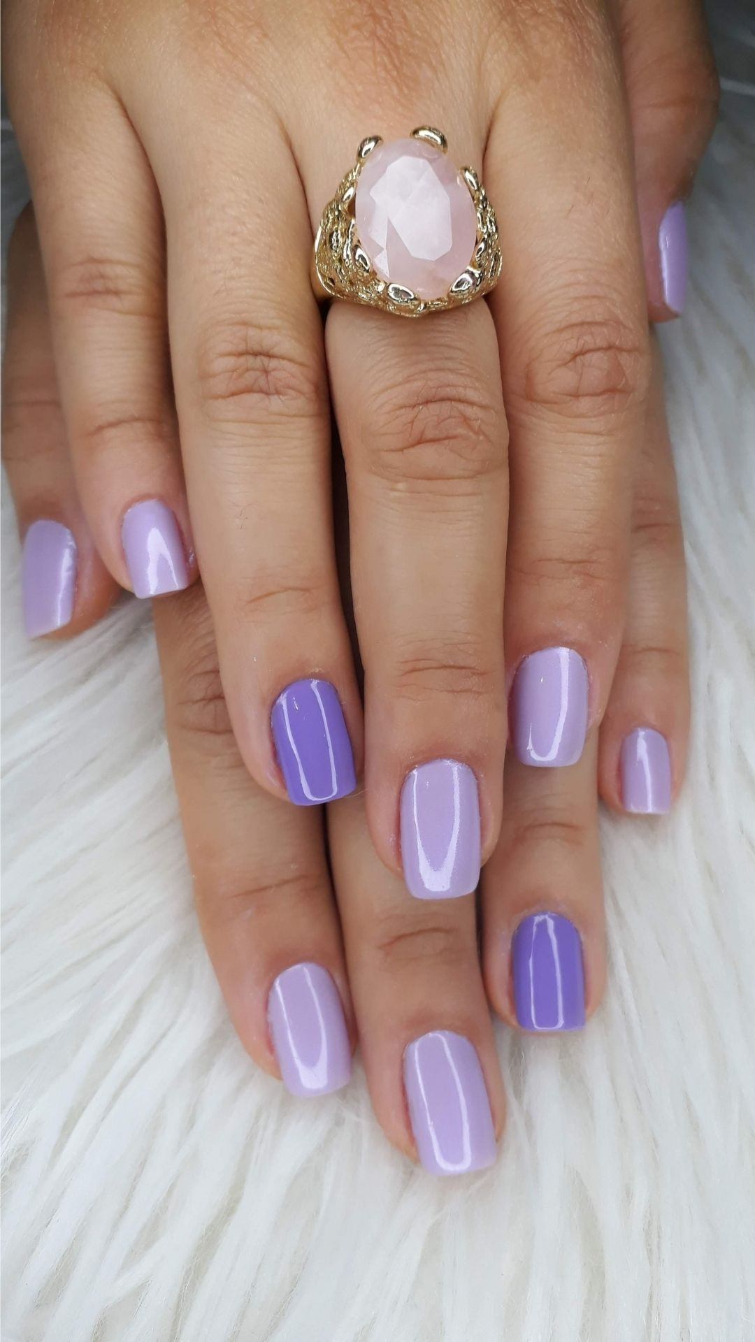 A-woman-showing-her-painted-finger-nail-with-mixture-of-light-purple-and-dark-purple-nails-as-one-of-the-30-new-year-nail-designs