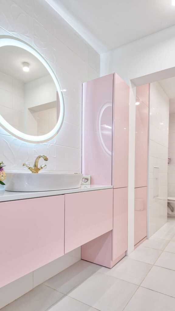 A-light-pink-bathroom-that-shows-a-mirror-that-has-in-built-light-and-it-also-shows-how-lighting-can-change-the-ambiance-of-a-bathroom