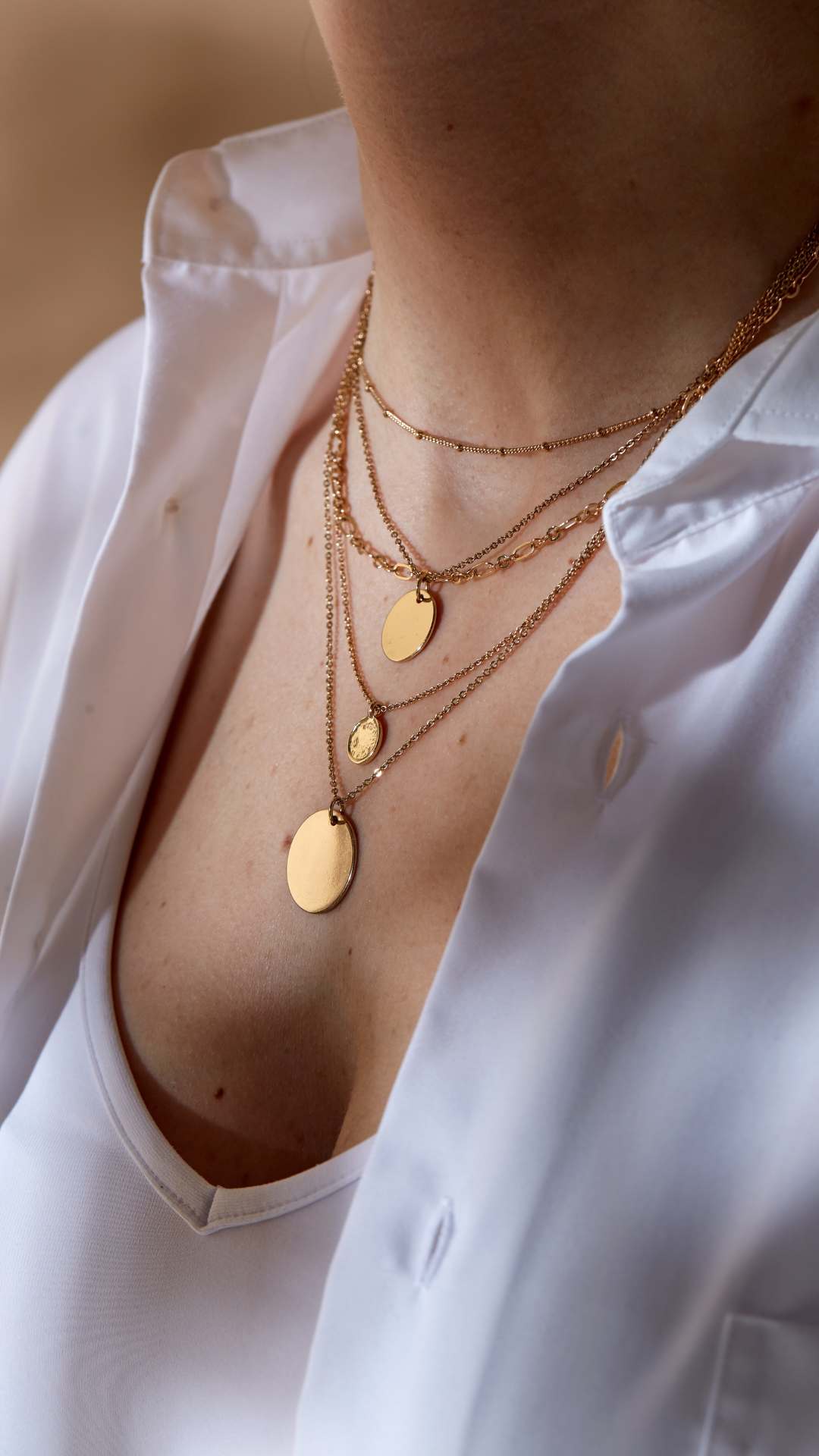 A-woman-wearing-layered-gold-necklace