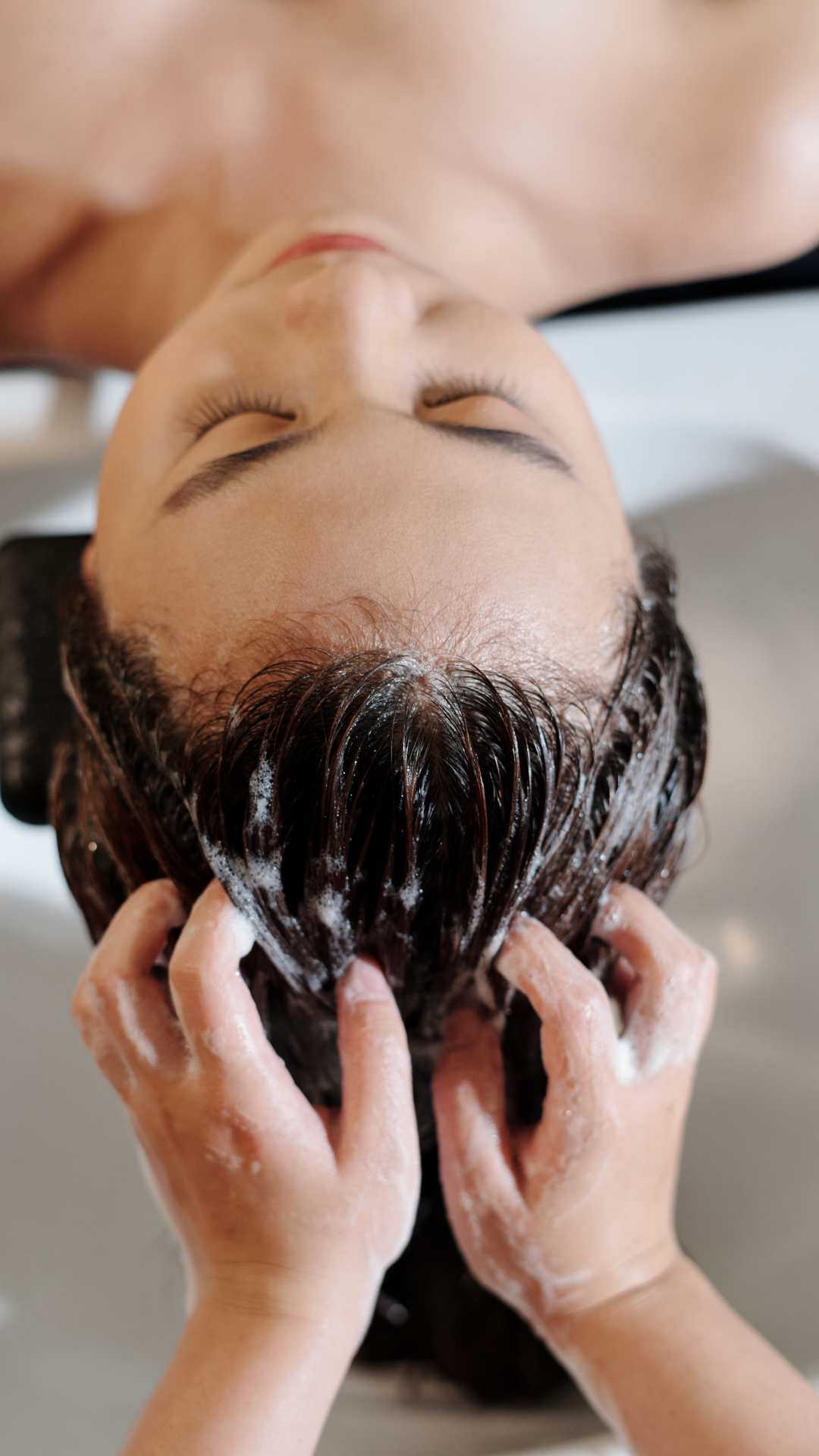 A-woman-that-someone-is-massaging-her-scalp