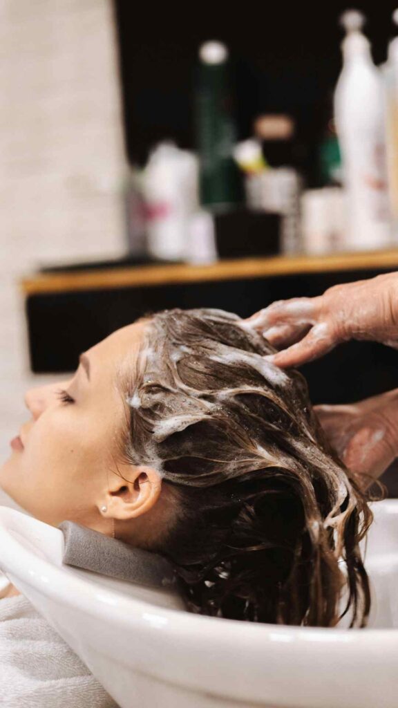 Woman-getting-her-hair-washed-gently-in-a-salon-as-part-of-ways-to-treat-dandruff