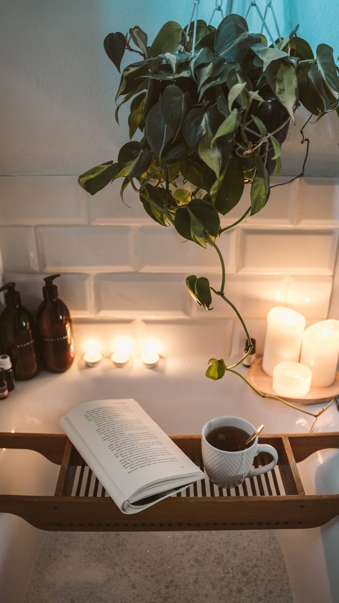 A-cozy-bath-tub-that-has-candle-scents-coffee-body-wash-a-book-and-a-flower-ready-to-use