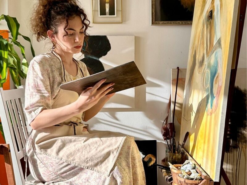 An-image-of-a-woman-in-a-room-showing-pictures-on-the-wall-as-one-of-the-15-new-year-wall-decor