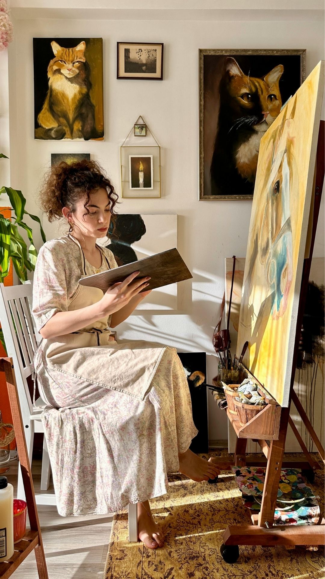 An-image-of-a-woman-in-a-room-showing-pictures-on-the-wall-as-one-of-the-15-new-year-wall-decor