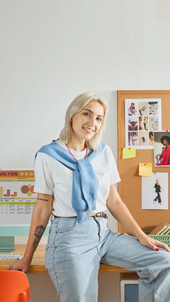 Woman-stylishly-dressed-in-jean-pants-and-a-white-top-accessorized-with-a-scarf-around-her-neck.