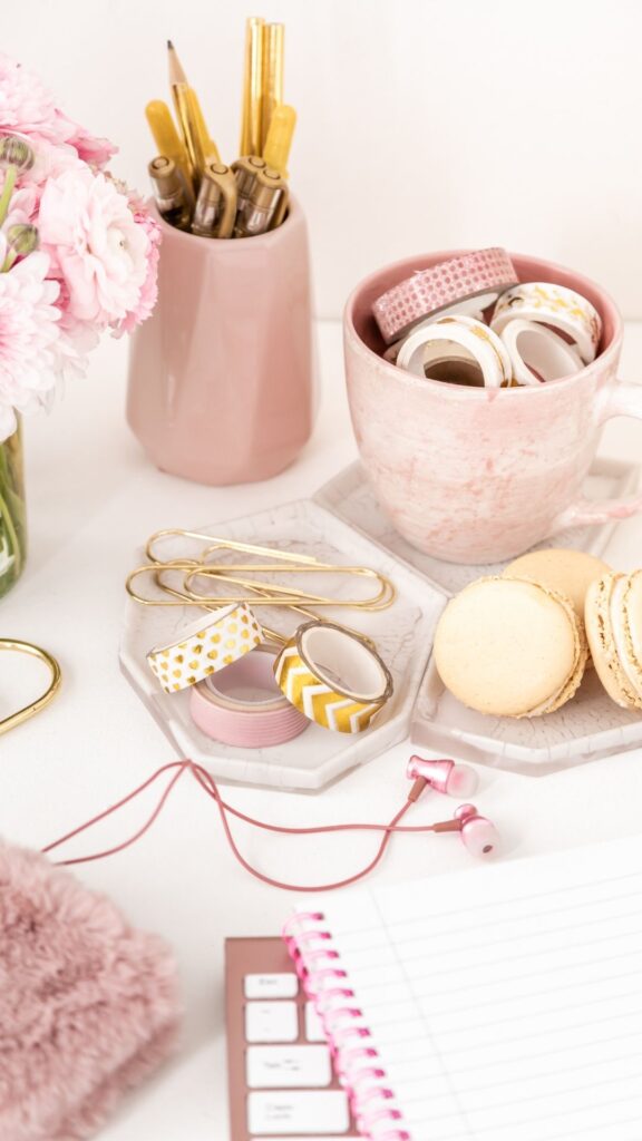 Delicate-feminine-stuff-like-a-pink-small-flower-vase-a-cup-and-pens-that-makes-our-reading-table-aesthetic