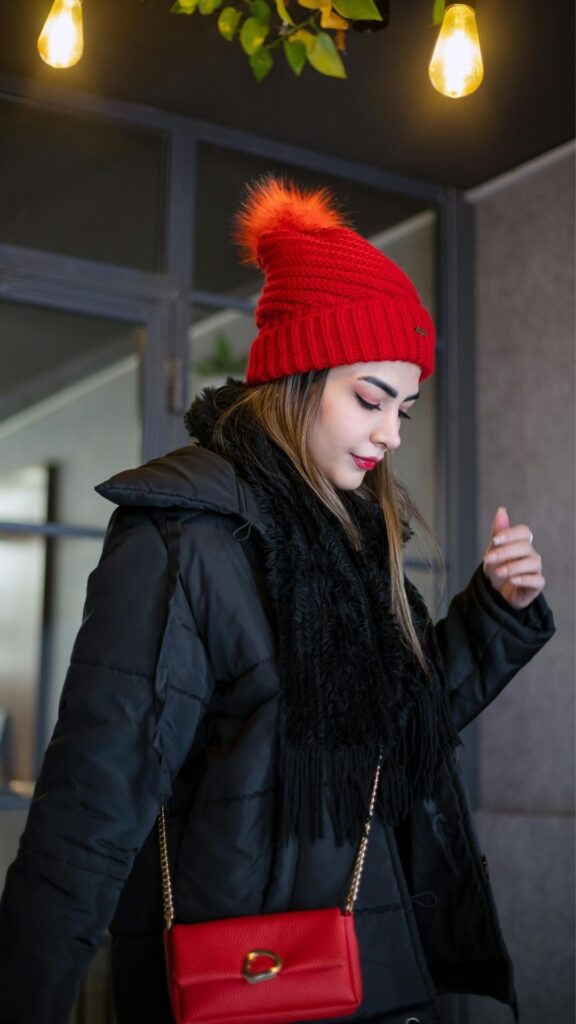 A-woman-wearing-a-cute-red-beanie-a-red-cross-bag-black-jacket-and-a-scalves