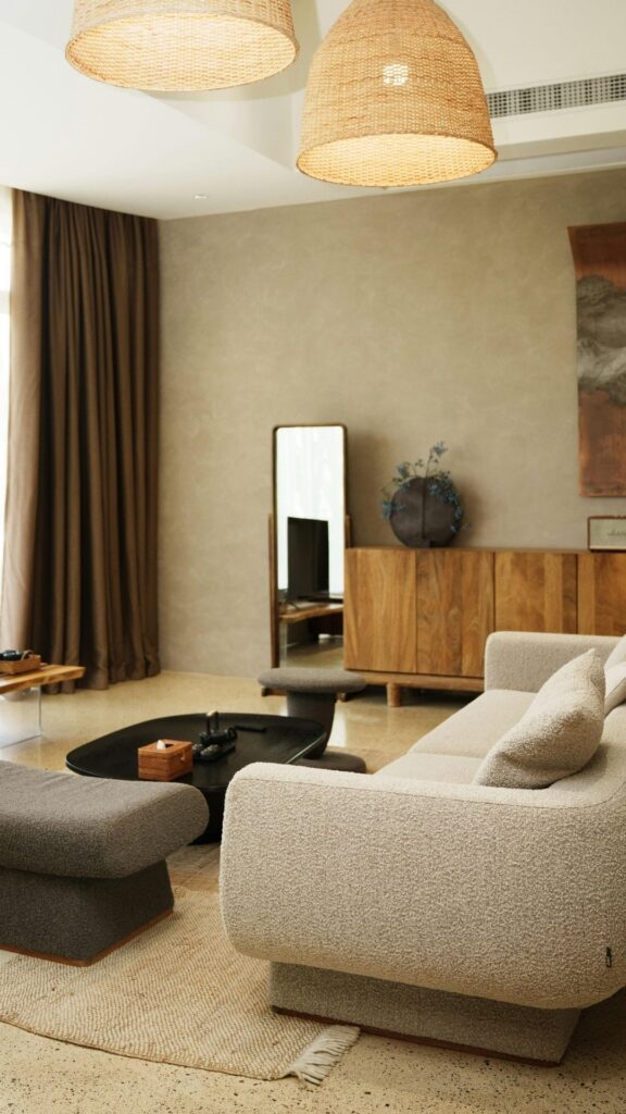 A-living-room-showing-a-neutral-colored-couch-table-rug-mirror-at-the-wall-and-rug