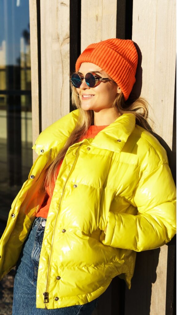 A-woman-wearing-yellow-Puffer-jackets-and-orange-beanie-with-orange-top -as-her-15-winter-fashion-inspo