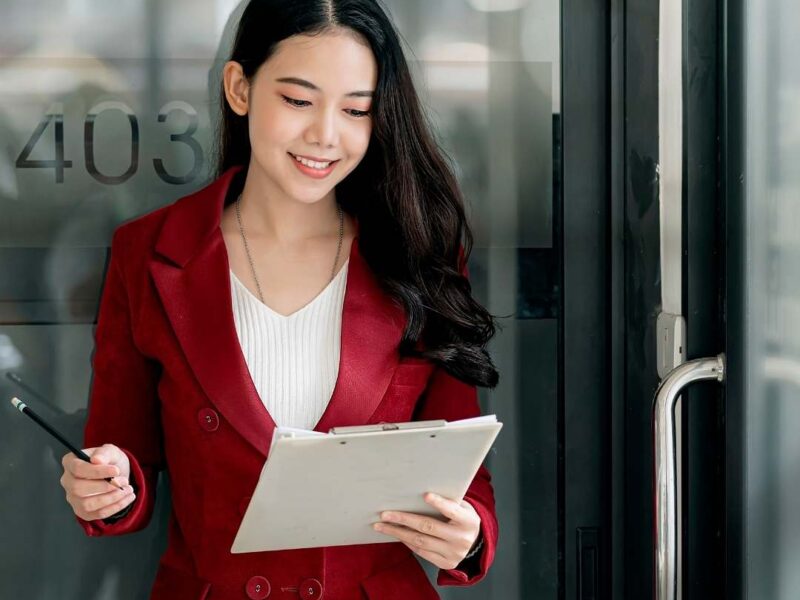 Valentine’s-Day-work-outfit-featuring-a-woman-wearing-a-white-inner-top-white-trousers-and-a-red-buttoned-blazer-in-a-professional-office-style.