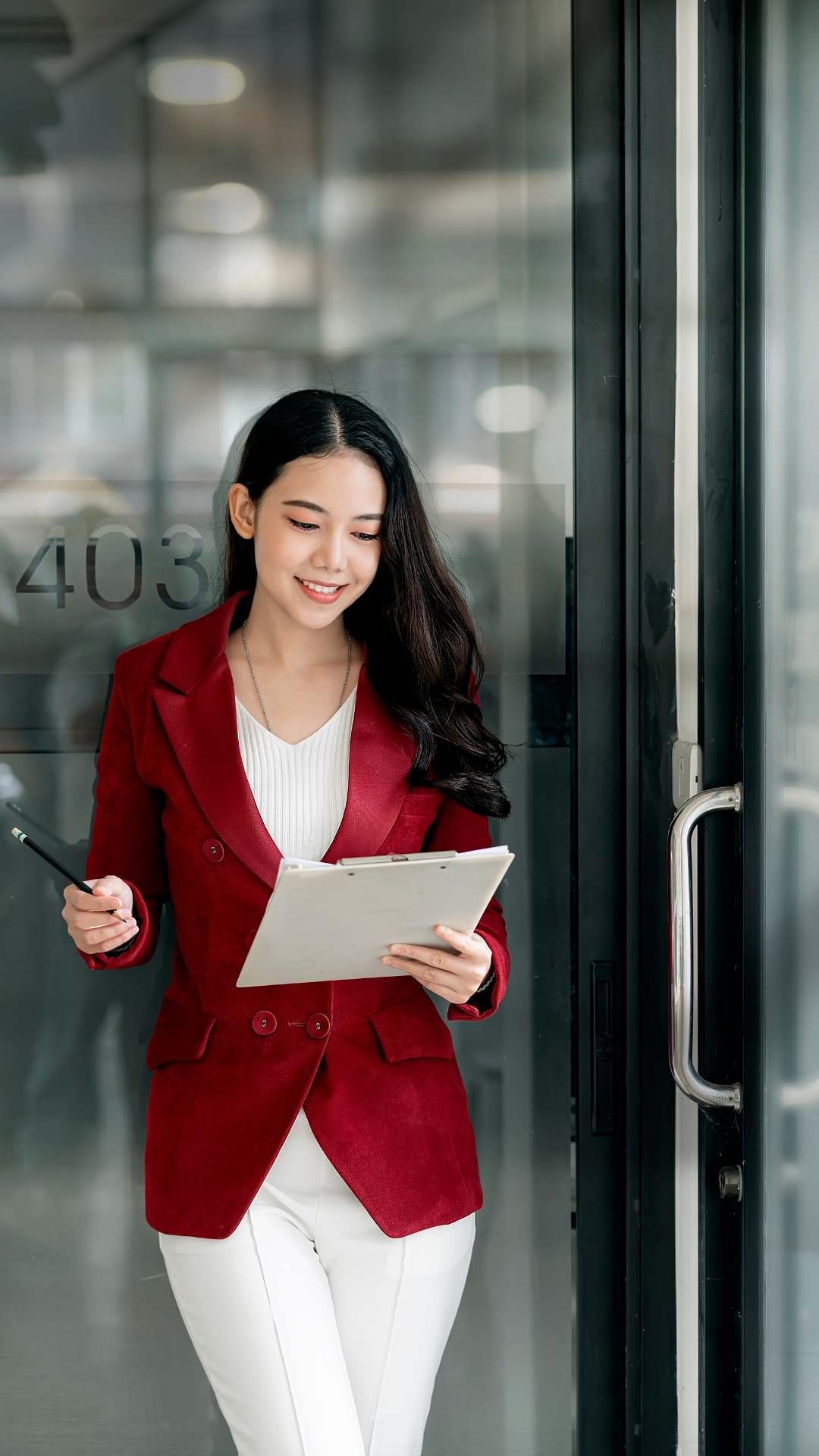 Valentine’s-Day-work-outfit-featuring-a-woman-wearing-a-white-inner-top-white-trousers-and-a-red-buttoned-blazer-in-a-professional-office-style.
