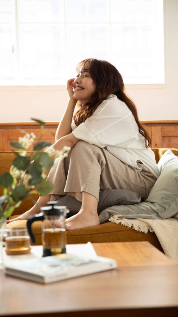 Comfortable-Valentine’s-Day-outfit-for-home-as-a-woman-sits-on-a-couch-perfect-for-cozy-and-relaxed-settings.