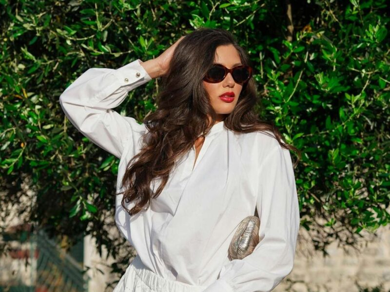 Fashionable-spring- outfits-for-women-featuring-a-white-flare-skirt-matching- top-and-accessories-including-hat-and-sunglasses.