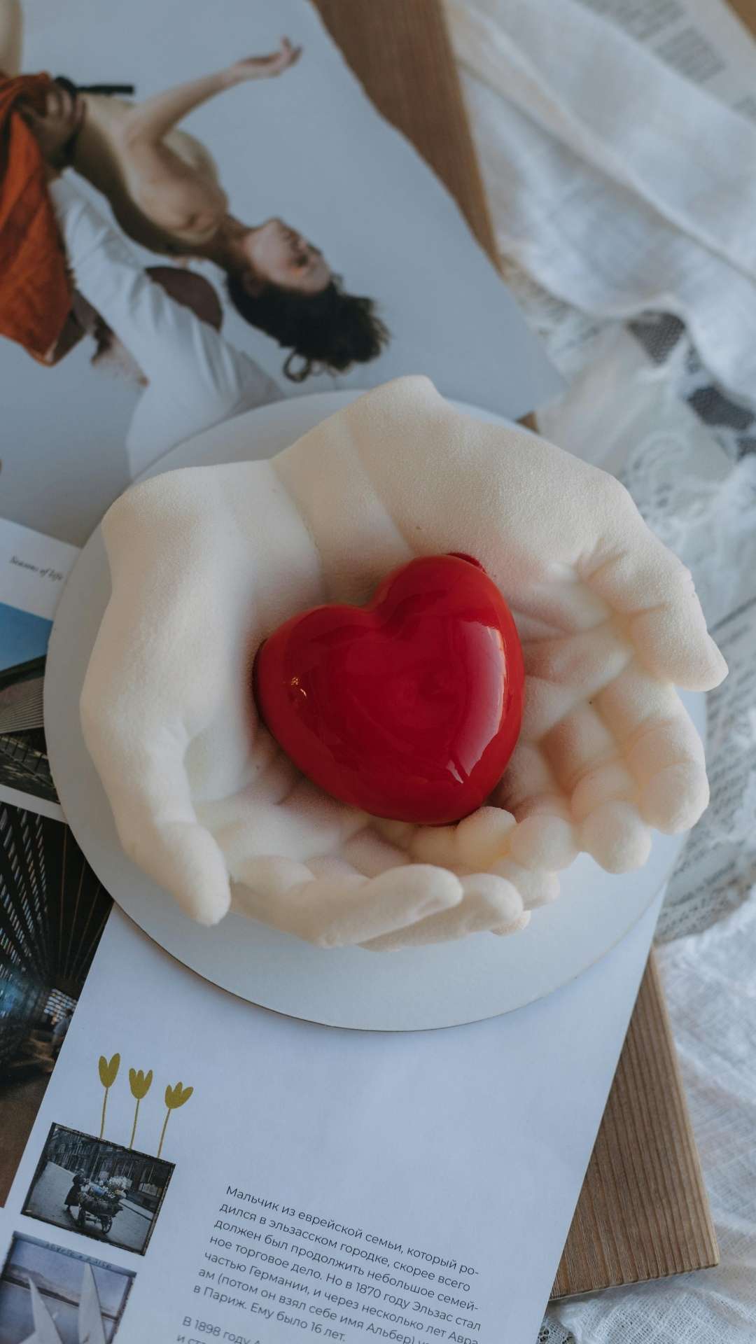 Aesthetic-Valentine’s-Day-wallpaper-featuring-a-stylish-woman-in-red-lying-gracefully-on-a-romantic-background- alongside-hands-forming-a-heart-shape-on-a-white-plate-conveying-love-and-Valentine’s-Day-mood.