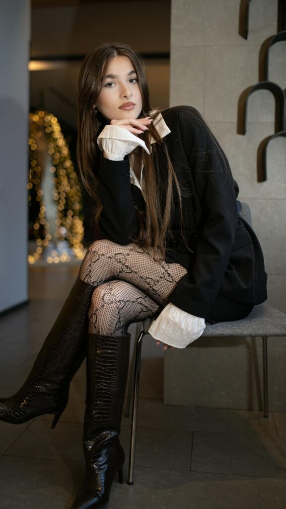 A-woman-wearing-a-black-gown-and-a-host-as-her-summer-outfit-fashion-trends