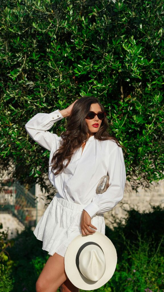 A-woman-wearing-white-short-gown-with-white-hat-as-her-coachella-outfit-ideas-for-women