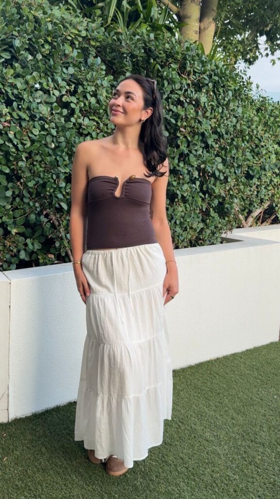 A-woman-white-wearing-maxi-skirt-and-brown-top
