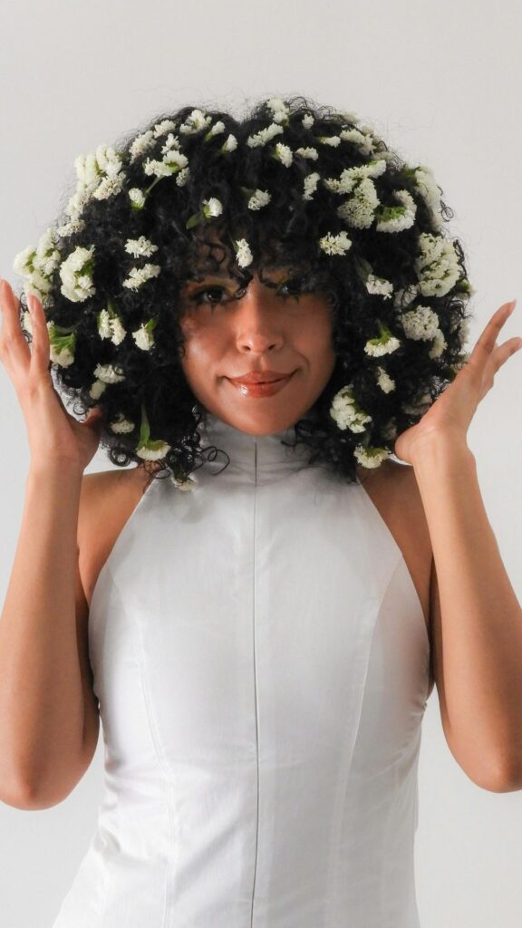 A-woman-with-flowers-on-her-hair-for-spring-hairstyle-ideas