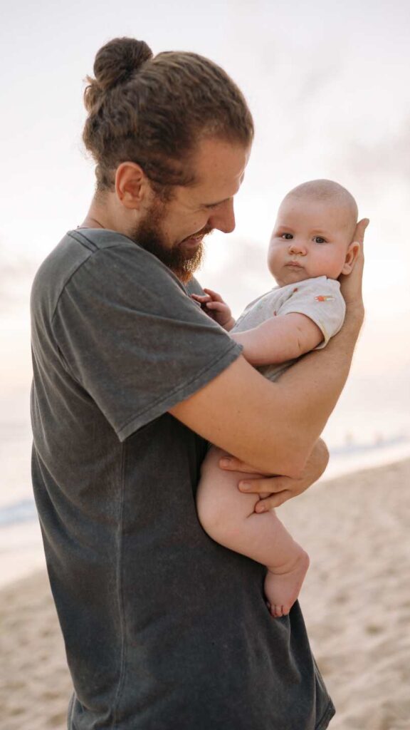 A-dad-in-the-beach-holding-he's-child