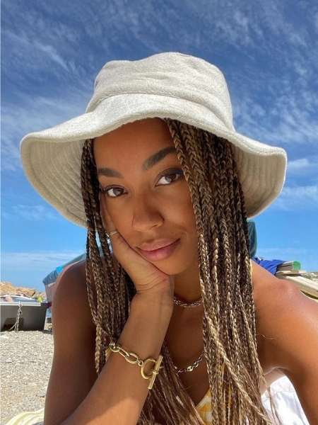 A-woman-on-Braids-Under-a-Hat