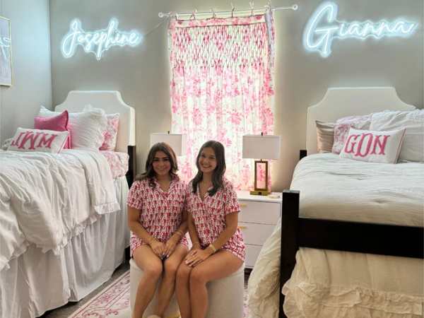 Featured-Image-of-college-dorm-decor-ideas-showing-2-girls-sitting-in-the-middle-of-their-dorm