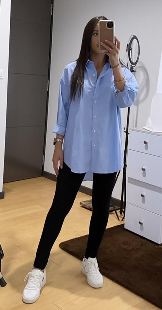 A-woman-wearing-blue-Oversized-Button-Down-Shirt-and-black-Leggings-as-her-work-from-home-outfit-ideas-for-women