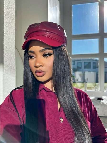 A-woman-on-Straight-Sleek-Hair-Under-a-Hat-as-her-15-trendy-hat-hairstyles-for-long-hair