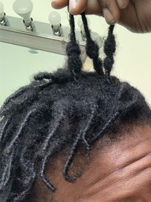 3rd-stage-of-starter-locs-which-is-budding-and-a-man-showing-3-of-hes-bud-strands