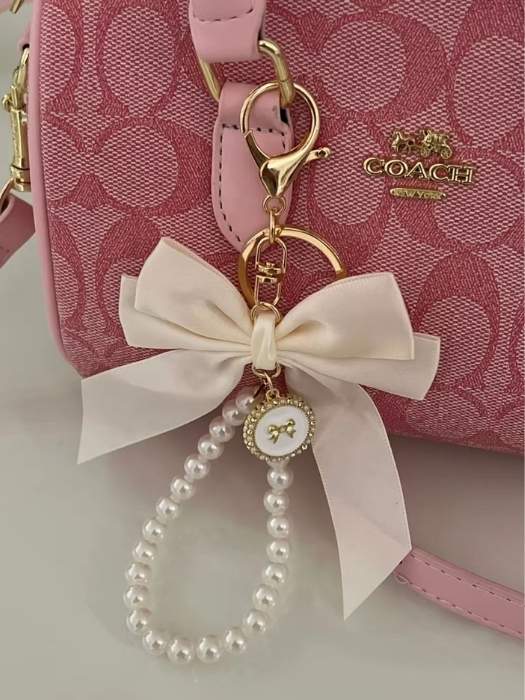Pink-bag-that-has-a-cute-bag-charm-in-the-hand-side