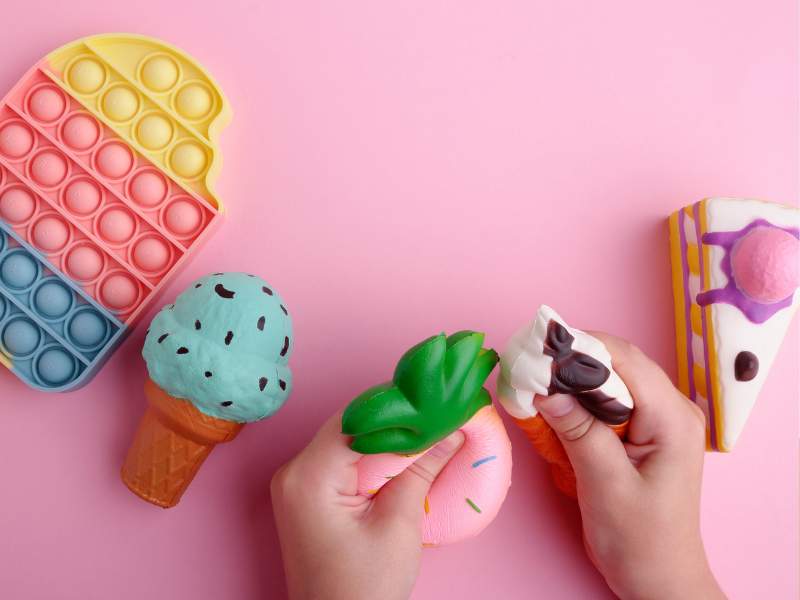 Featured-Image-Of-DIY-Squishy-showing-an-ice-cream-a-cake-and-other-squishes-on-a-pink-background