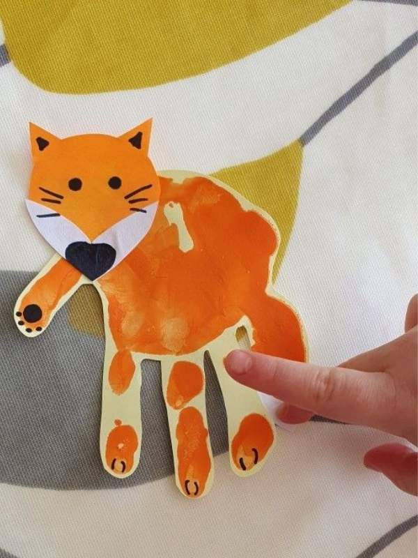 An-image-showing-Handprint-Fox-Craft-colored-with-orange-as-fall-handprint- crafts-for-preschoolers