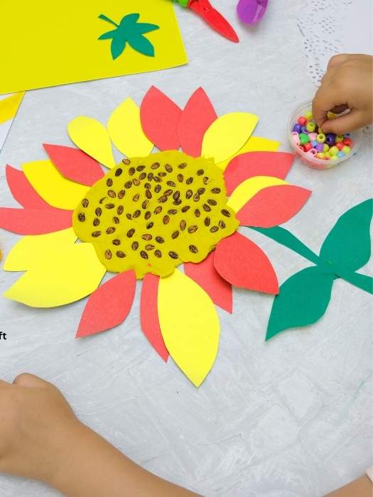 Paper-Plate-Sunflower-craft-showing-a-child-creating-her-craft