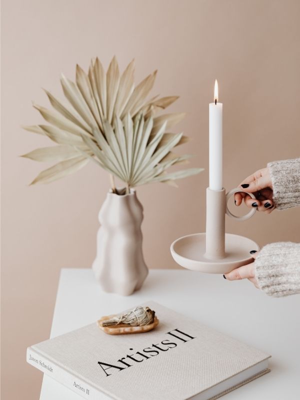An-image-of-well-arranged-table-with-lady-placing-a-candle-in-the-middle-of-the-table