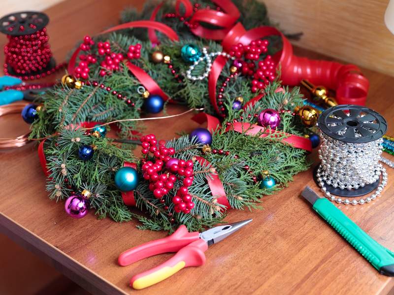 Featured-image-of-DIY-Christmas-wreath-ideas-showing-picture-of-wreath-on-the-table-and-equipment-used-in-making-it