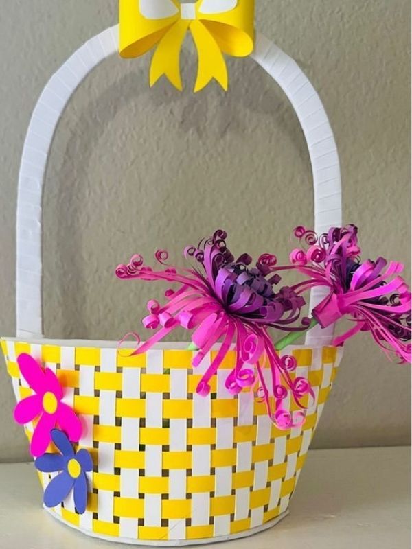 DIY-paper-basket-woven-with-yellow-and-white-paper-strips-and-decorated-with-pink-flowers