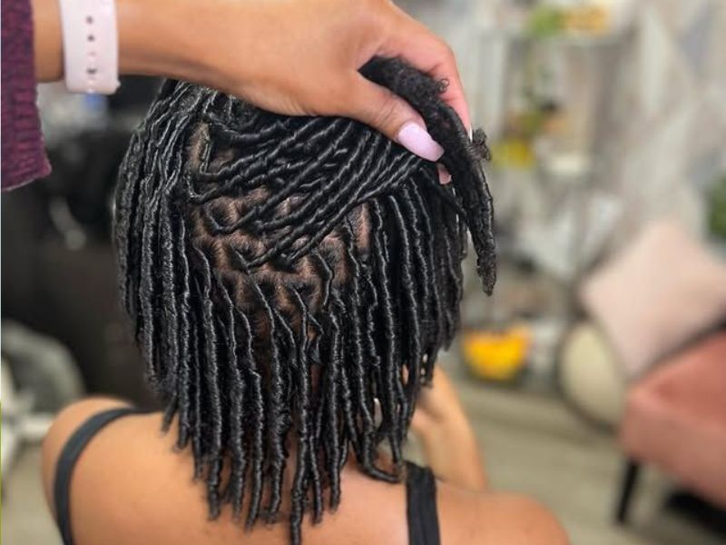 Featured-Image-of-Comb-Coils-for-Starter-Locs-showingg-image-of-a-woman-seated-down-while-another-person-is-making-her-locs