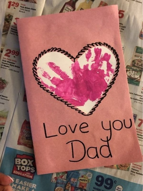 A-pink-paper-with-love-shaped-in-the-middle-that-shows-kids-hand-print-also-written-I-Love-You-Papa