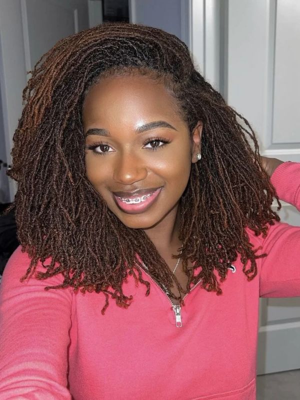 An-Image-of-a-woman-wearing-pink-with-micro-locs